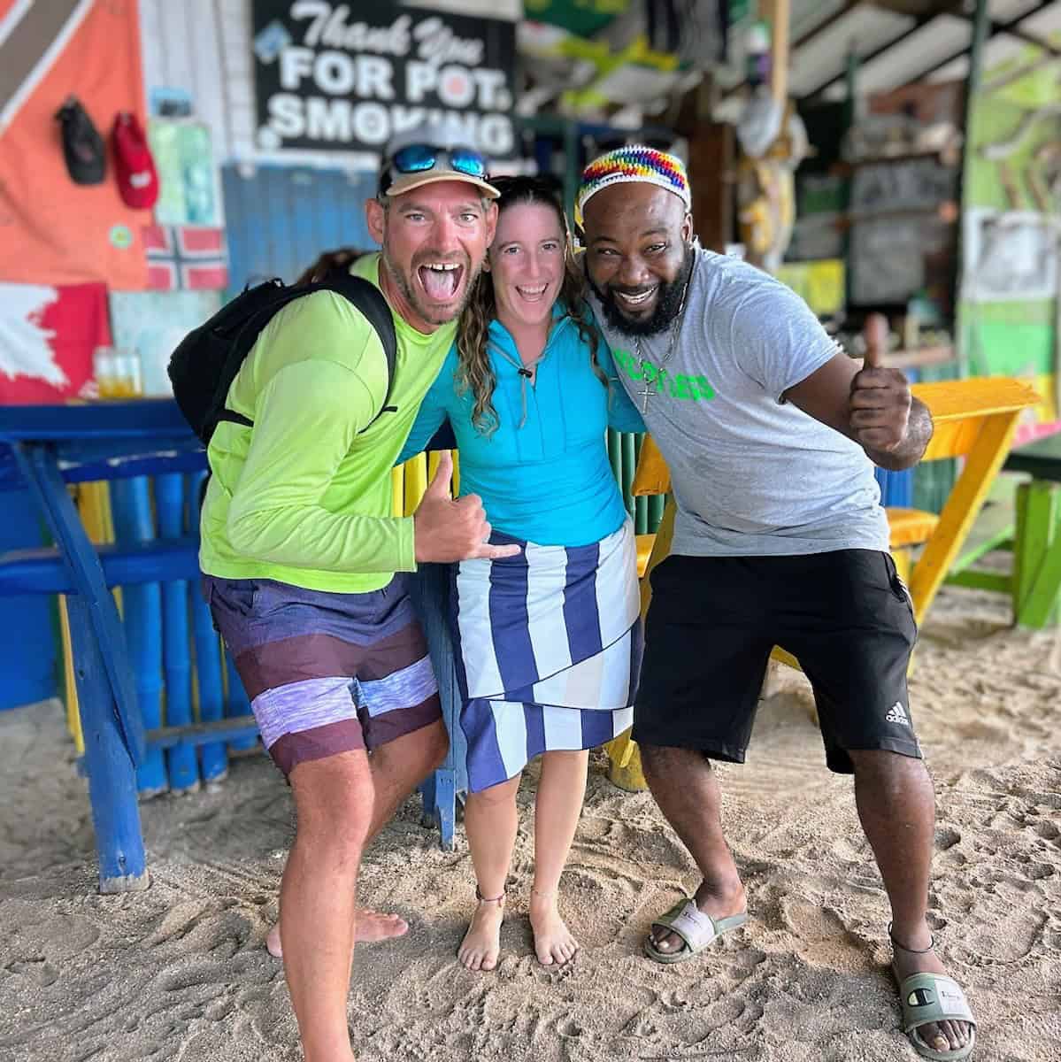 girl and guy with owner at his colorful Caribbean Beach Bar on Mayreau in the Grenadines