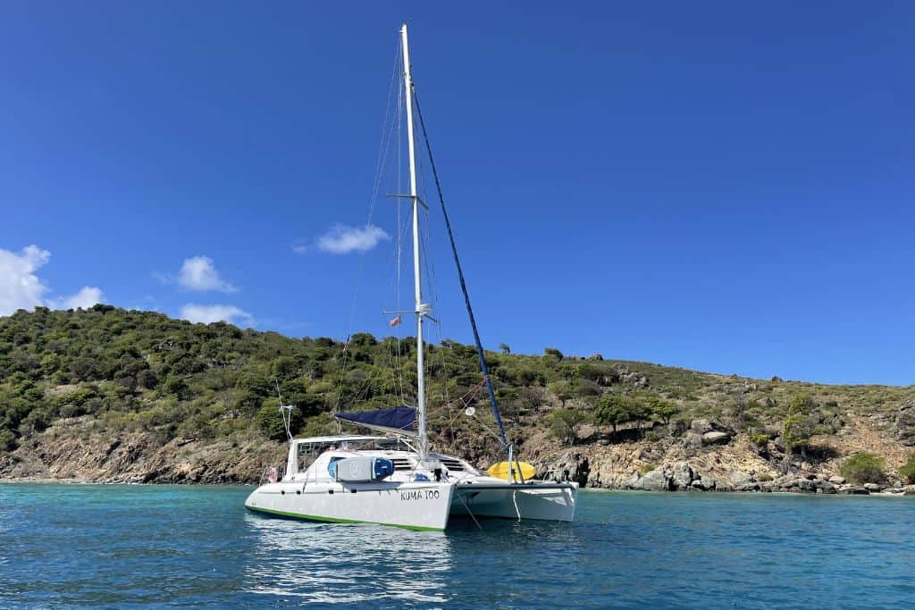 Sailing catamaran anchored in a secluded bay in the BVI