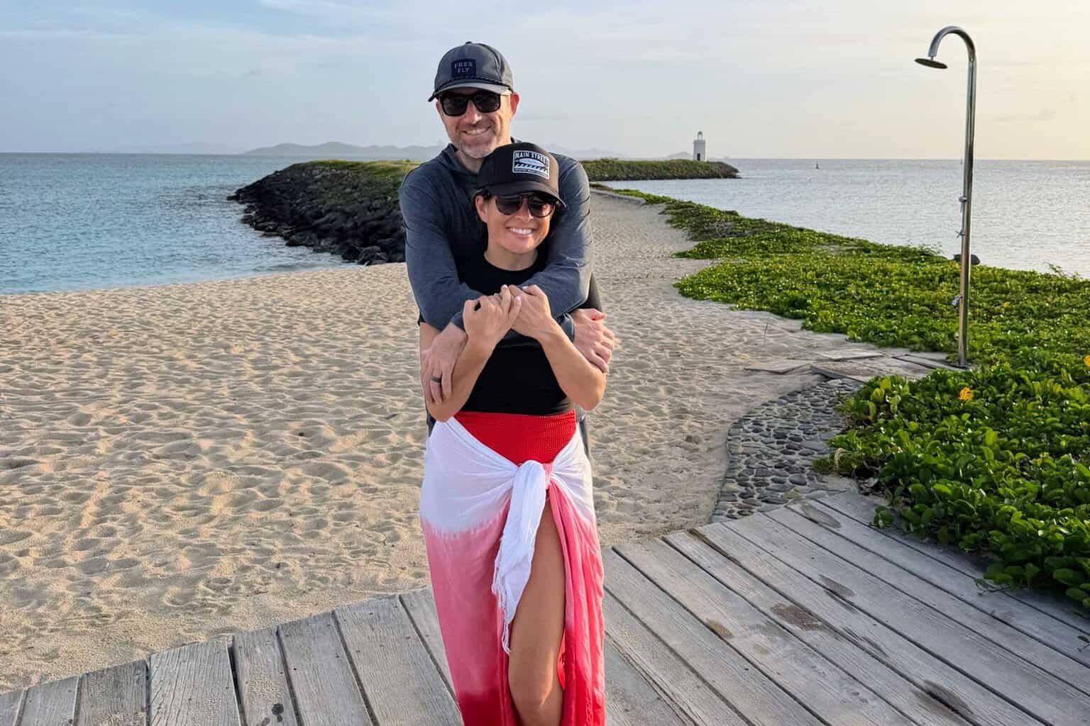 Couple wearing dryfit clothing, hats, and girl in a sarong 