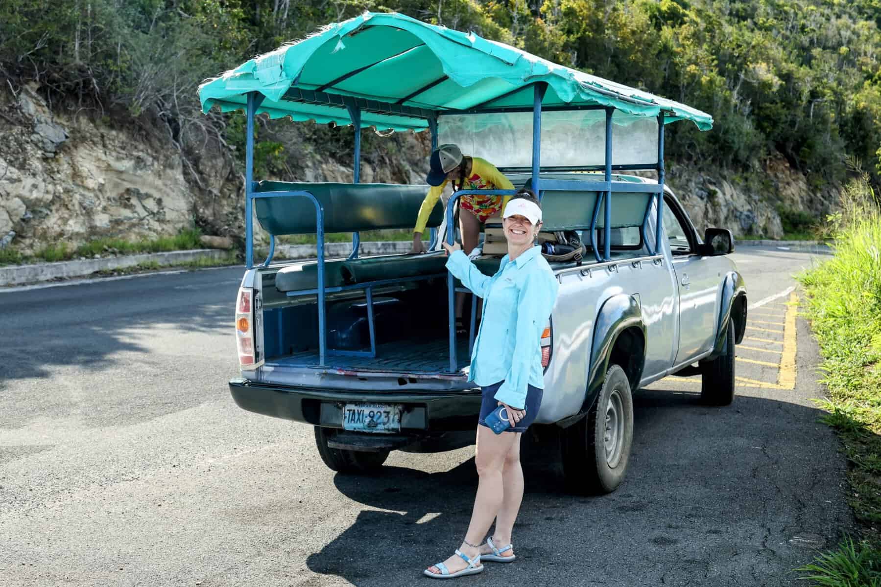 Island safari truck taxi with woman and child in lightweight sailing clothing, sun-protective swimsuit and hats