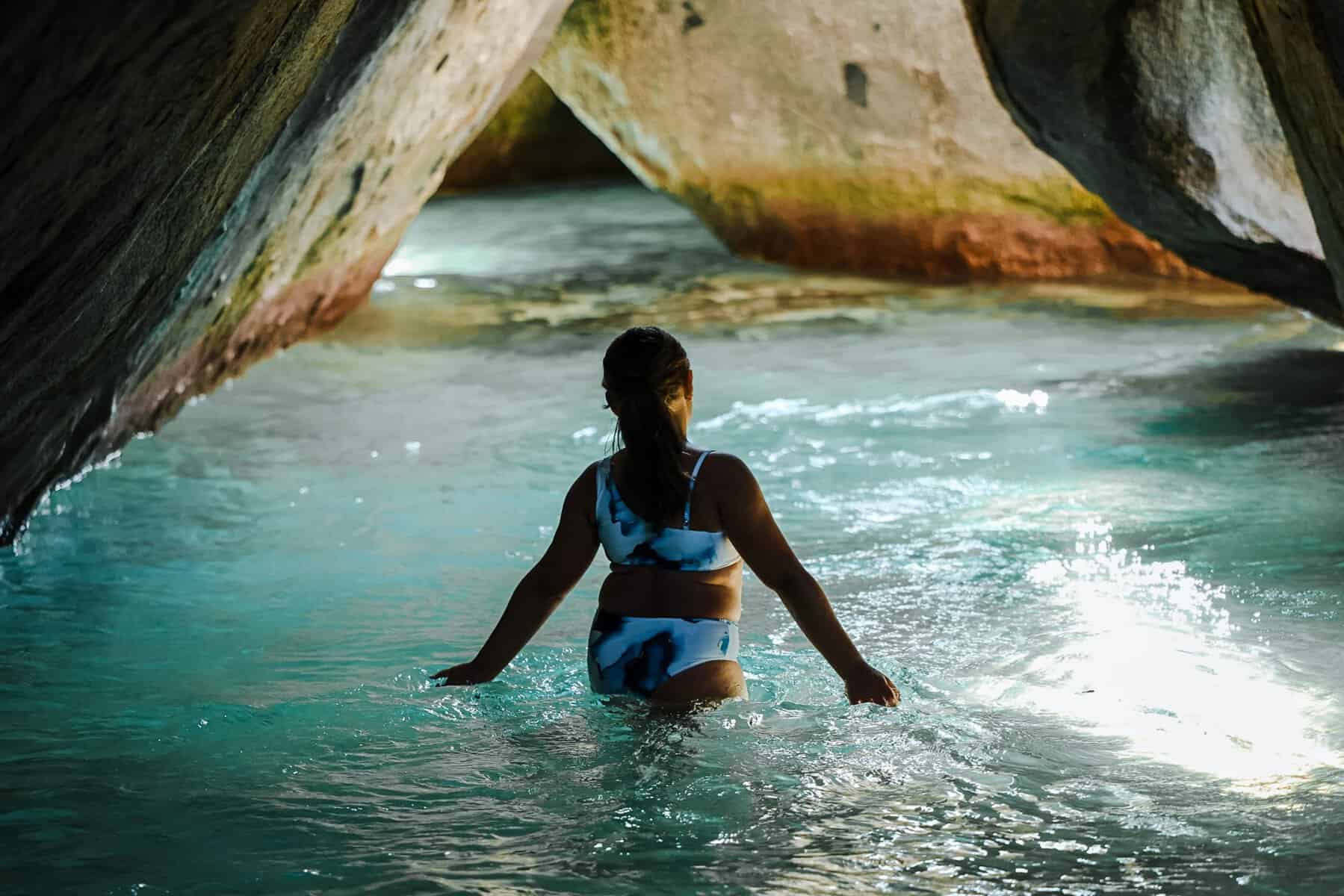 young girl in the shadows of the Cathedral room at the Baths British Virgin Islands