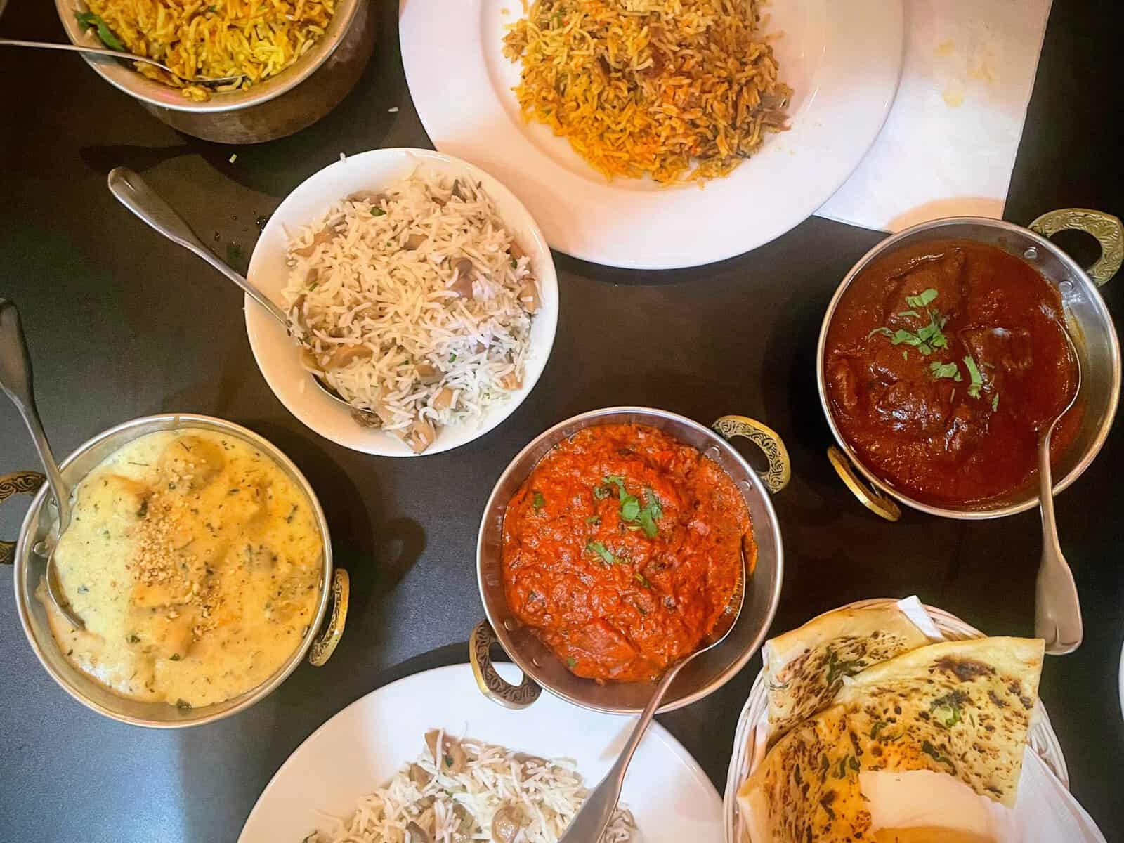 Table full of Indian food dishes in the British Virgin Islands