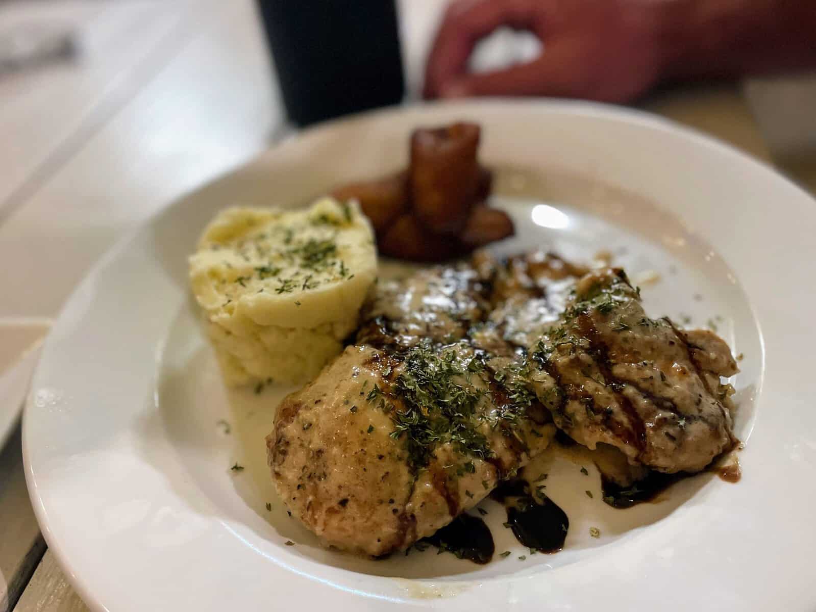 British Virgin Islands Food: fish, potatoes and plantains on a white plate