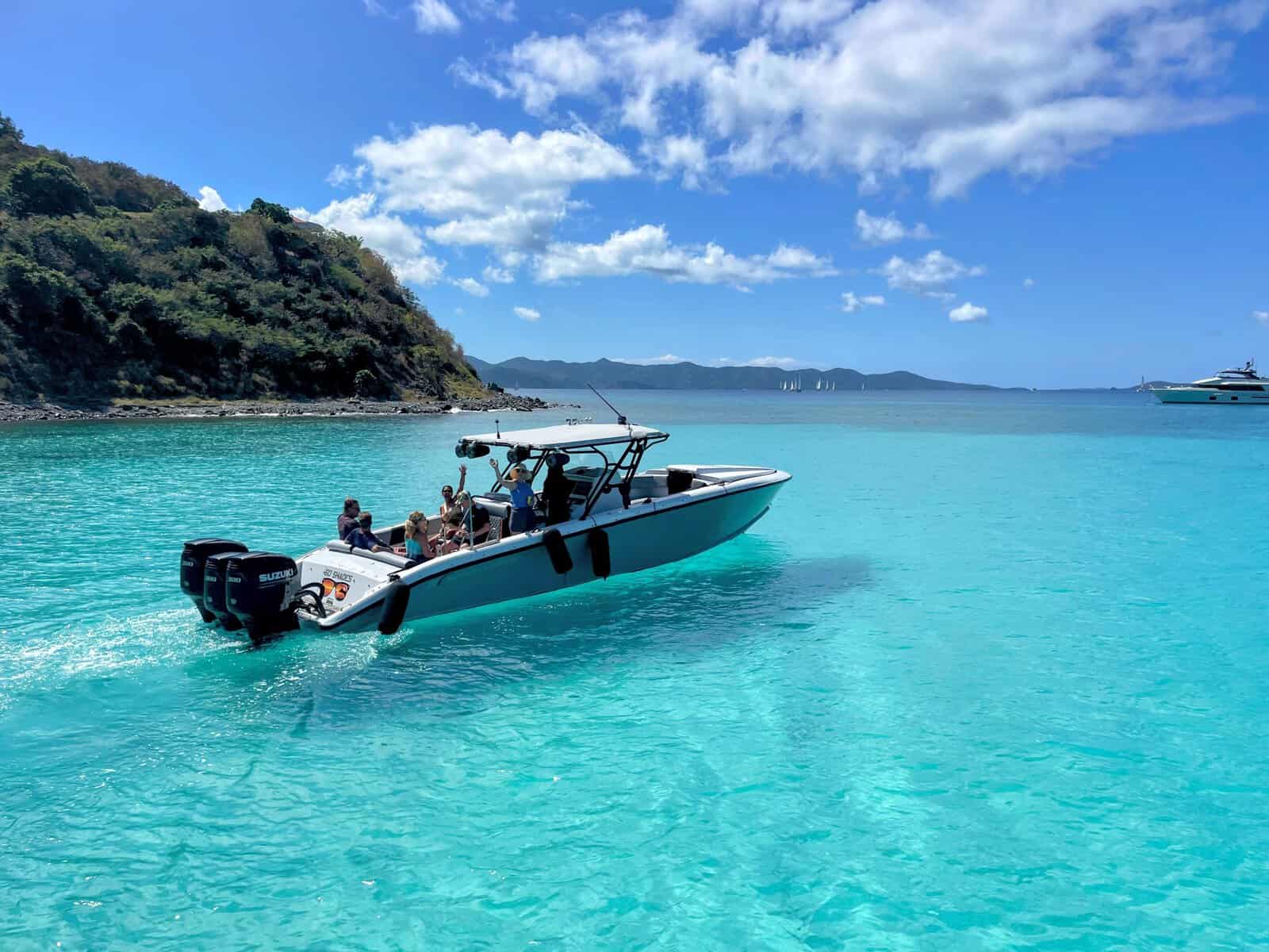 30-foot power boat with people on it preparing to go snorkeling in the British Virgin Islands