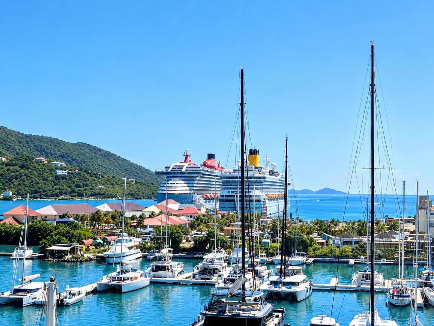 two cruise ship at Pier Park in Road Town, Tortola with sailing catamarans at the dock in the foreground 