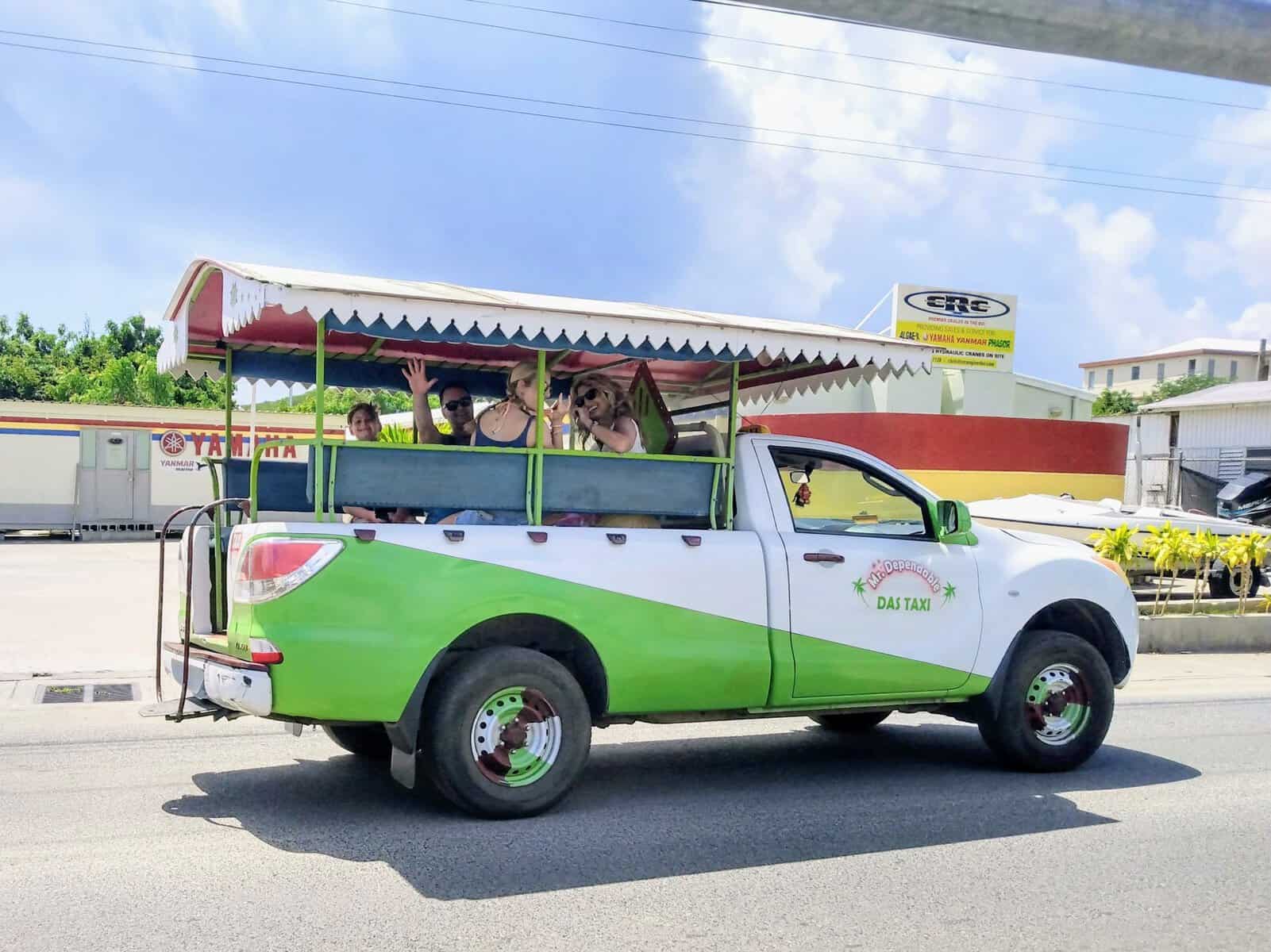 family in green and white safari taxi truck in British Virgin Islands