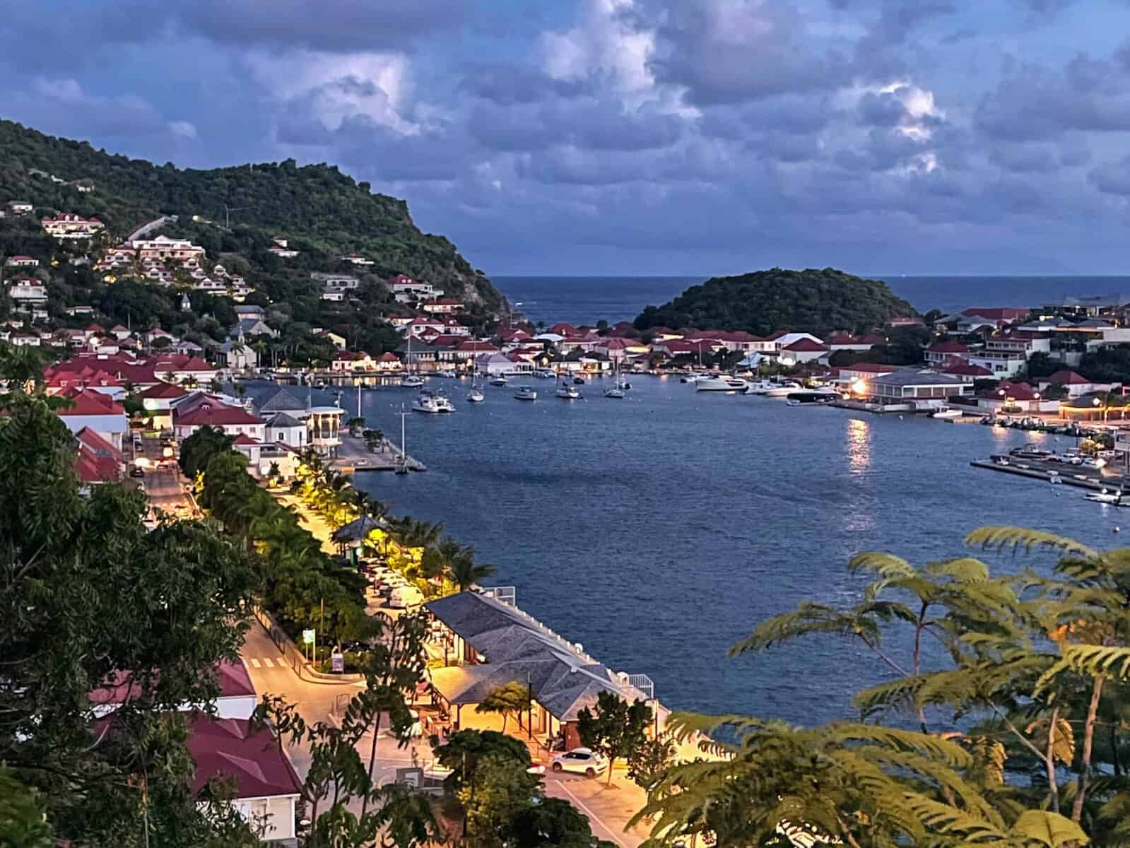 Gustavia Habour, St. Barths in the Caribbean as nighttime falls, lights on the buildings with red roofs