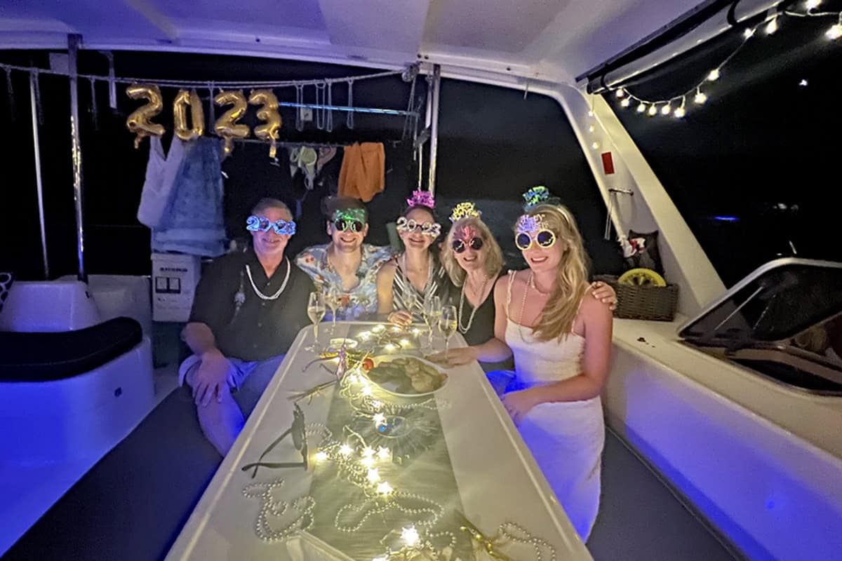 family on board a charter boat in the caribbean celebrating new year's eve